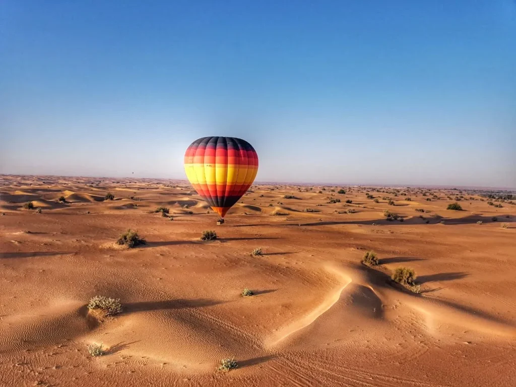 Hot air balloon over Dubai desert.