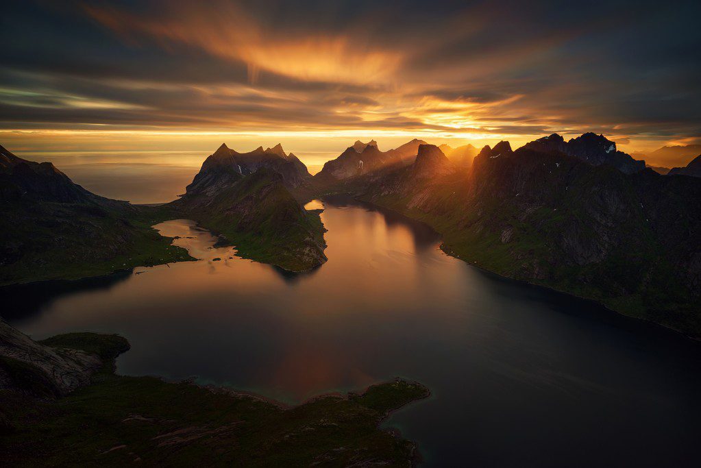 Midnight sun over mountains and fjord Lofoten