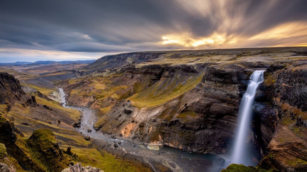 A breathtaking view of Aldeyjarfoss waterfall surrounded by basalt columns