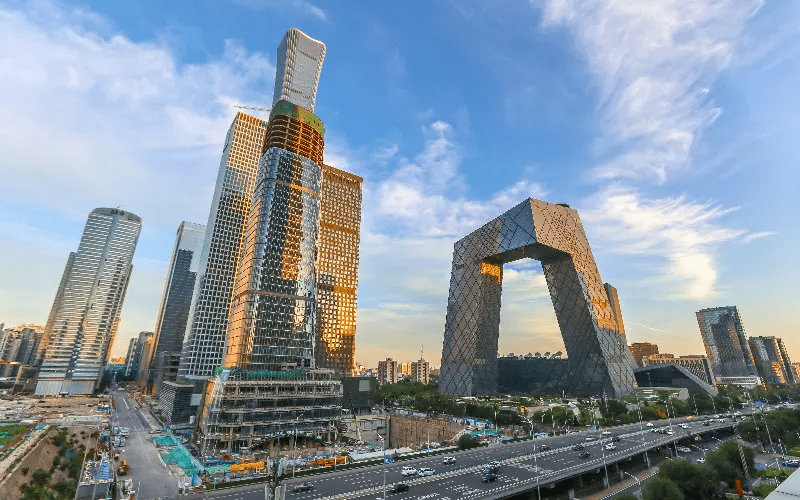 Modern cityscape with skyscrapers at sunset.