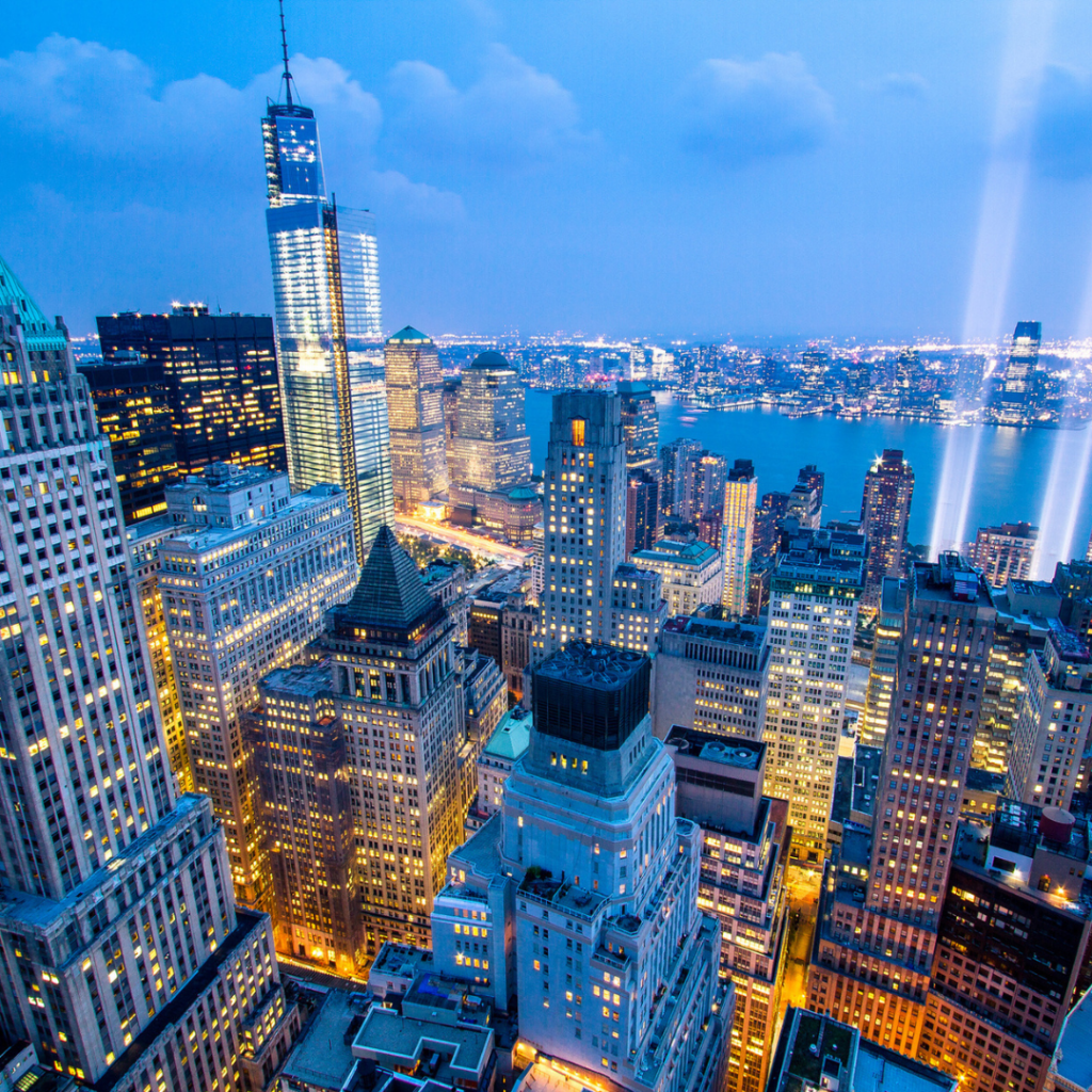 New York City skyline at dusk with lights.